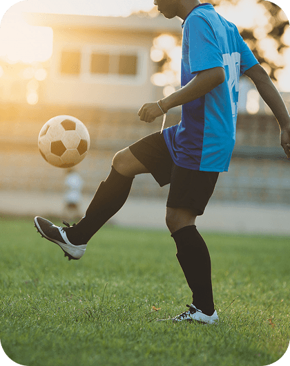 Football talent practicing skills on the pitch
